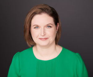 Smiling white woman in a green shirt